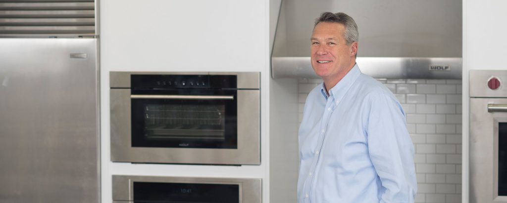 man standing in model kitchen