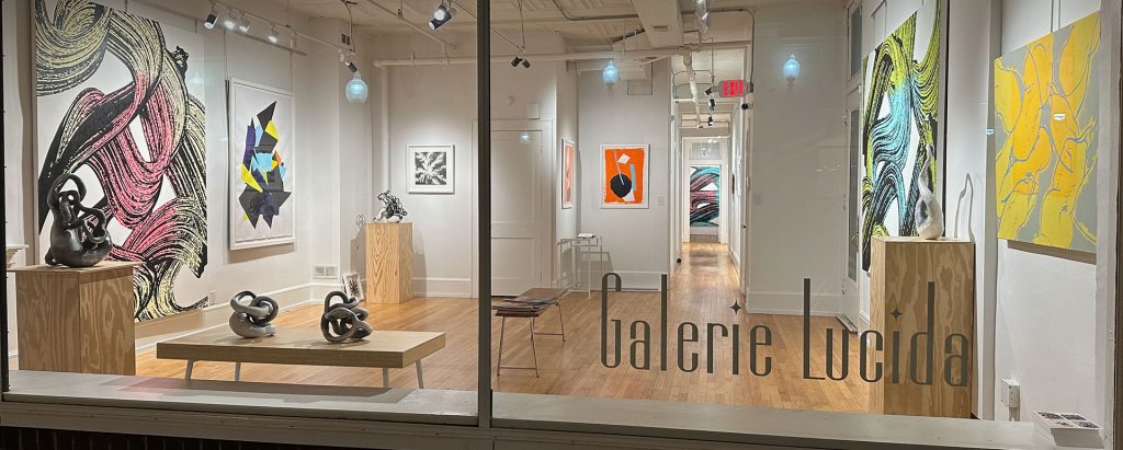 view through the windows of Galerie Lucida showing art installations