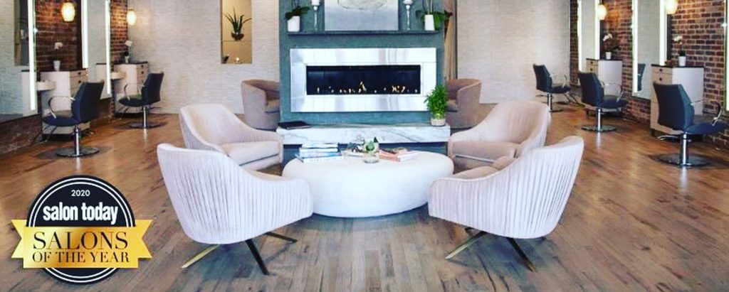 interior of Karen Joseph Salon showing seating and badge for "2020 Salons of the Year by Salon Today"